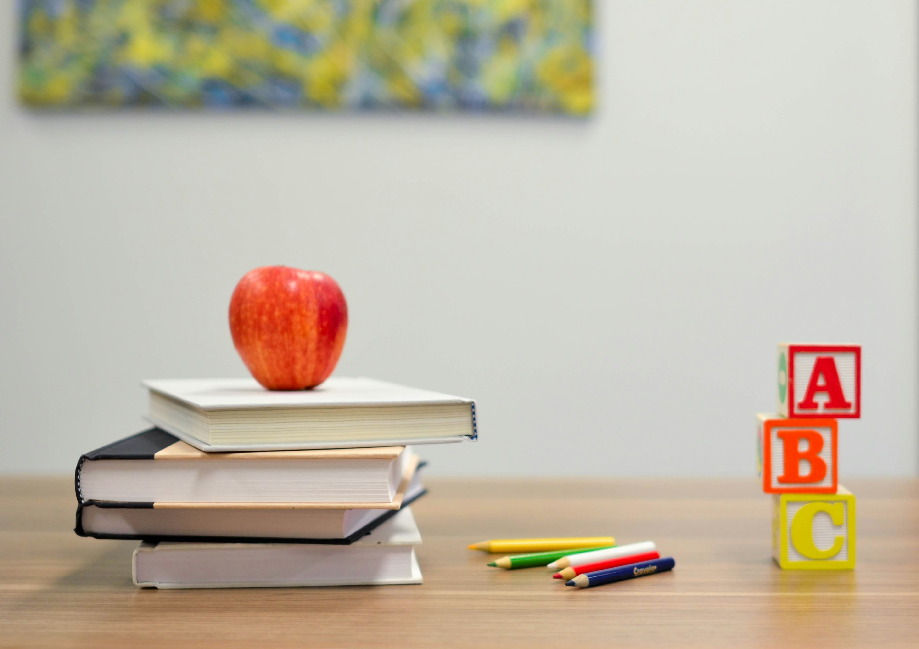 An open notebook and pen on a wooden desk, ready for building a German vocabulary list