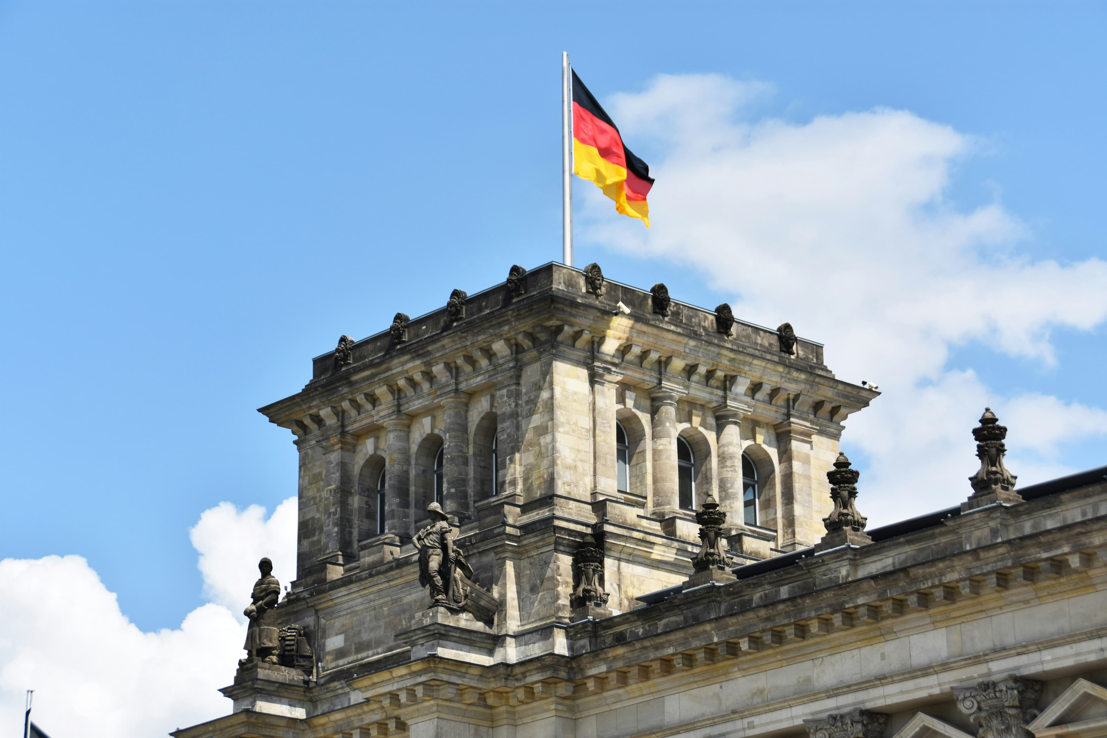 The German flag flying above the Reichstag building in Berlin, seat of the parliament that sets the citizenship language rules