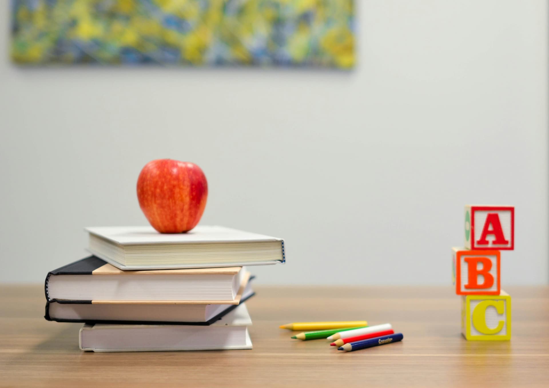 An open notebook and pen on a wooden desk, ready for building a German vocabulary list
